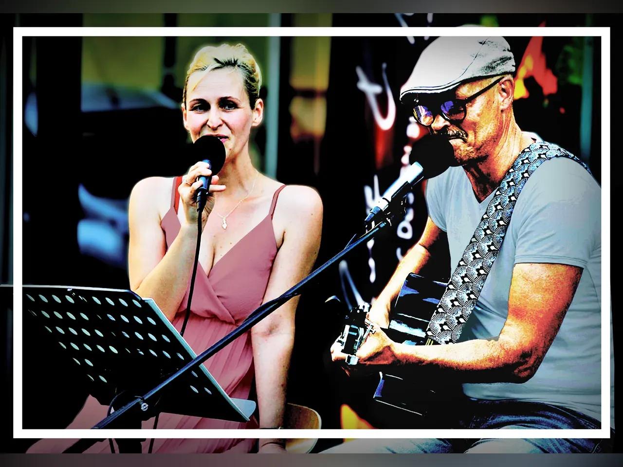 Zwei Musiker:innen mit Mikrofon und Gitarre